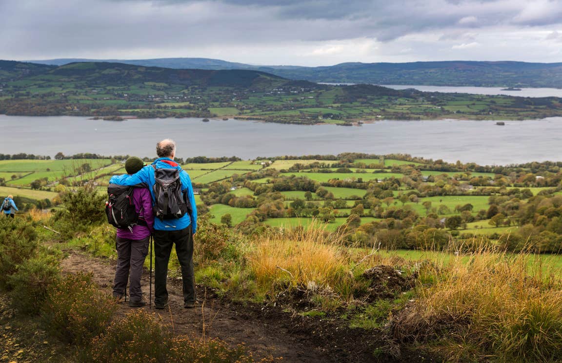 A couple hiking and looking out over water in Tipperary