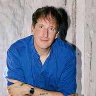 German producer and artist, Christian Löffler, man in dark blue shirt with arms crossed.