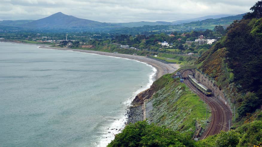 The DART line running past mountains by the coast at Vico, Dalkey, Dublin