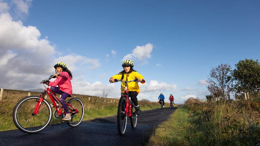 A family of four cycling the Great Western Greenway in County Mayo.
