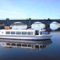 Silver Line Cruisers river queen boat on the water near a bridge