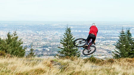 Ticknock Mountain Bike Trail Bike Rental and Guided Tours view of an airborne cyclist on a hill overlooking Dublin
