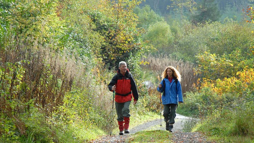 A man and a woman dressed in hiking gear walking the Attychraan Loop Walk