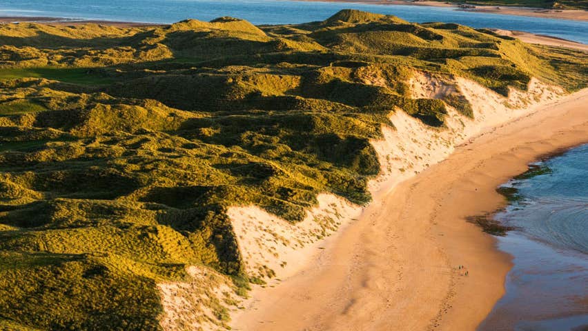 An aerial view of a beach with high sand dunes