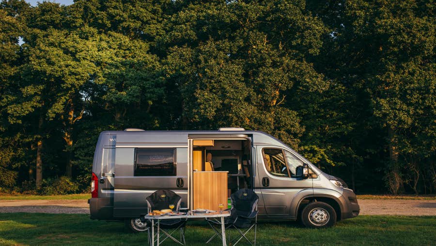 Camper with door open and table outside