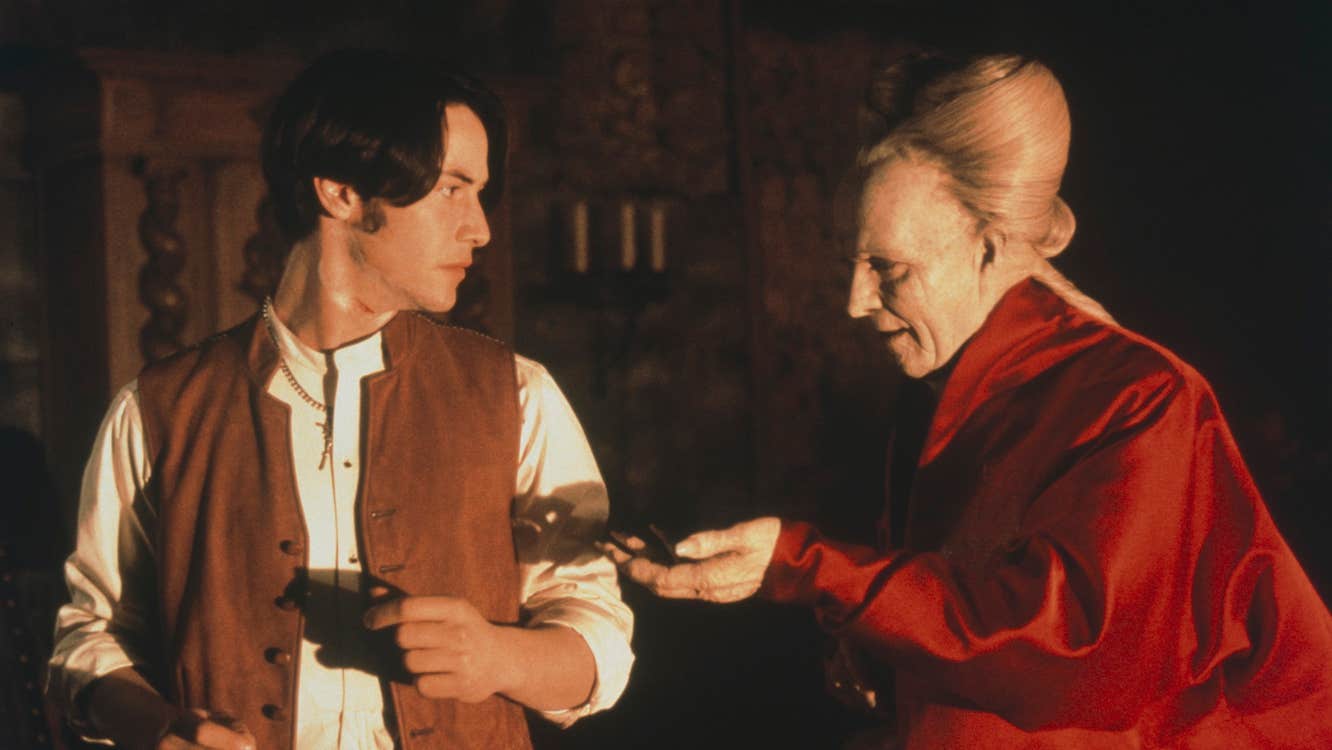 An old pale man is holding his hand out to an uncomfortable young man.