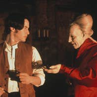 An old pale man is holding his hand out to an uncomfortable young man.