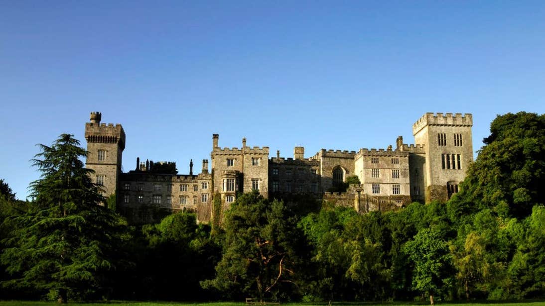 Lismore Castle in County Waterford on a sunny day under clear skies.