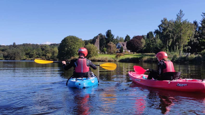 Two people kayaking on a river