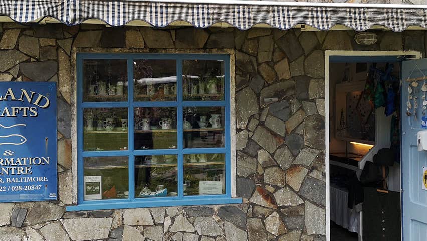 Traditional stone exterior wall and open door of Island Crafts