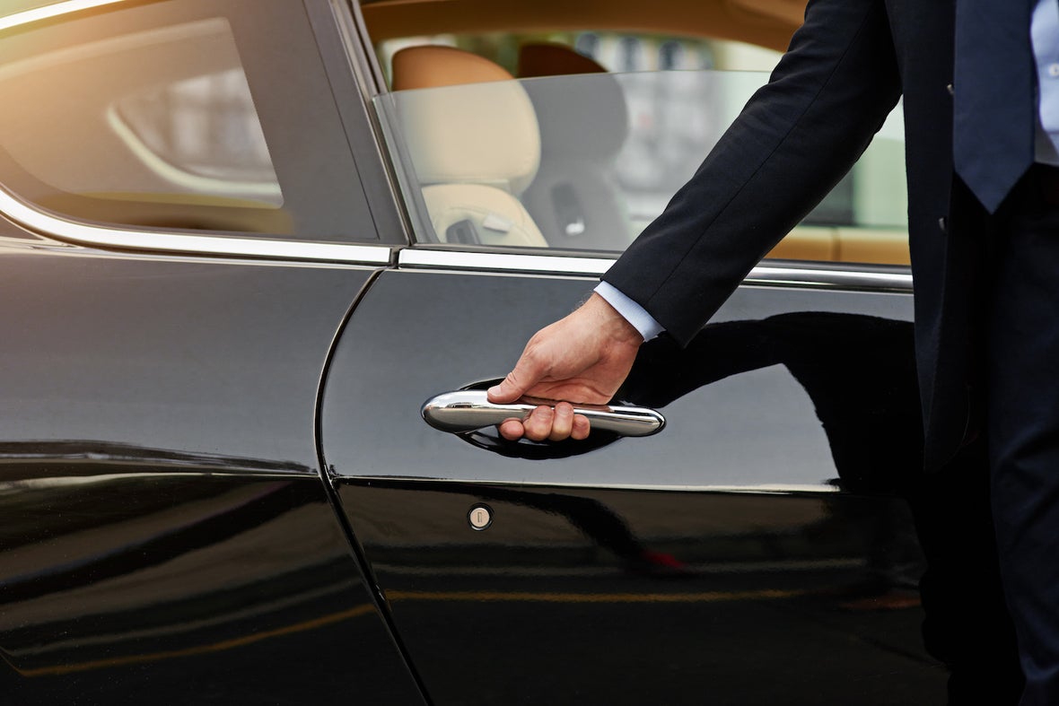 Image of a man opening a car door.