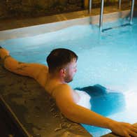 A person relaxing in a heated plunge pool at Helios Sauna Dundrum