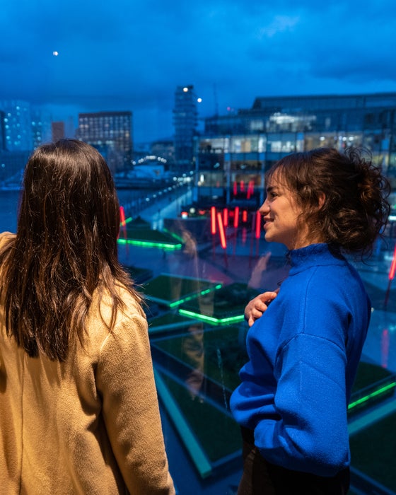 Two women looking out at Grand Canal Dock from the Marker Hotel in Dublin city