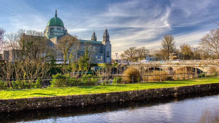 Gloomy skies over Galway Cathedral and a view of the Salmon Weir Bridge over the River Corrib