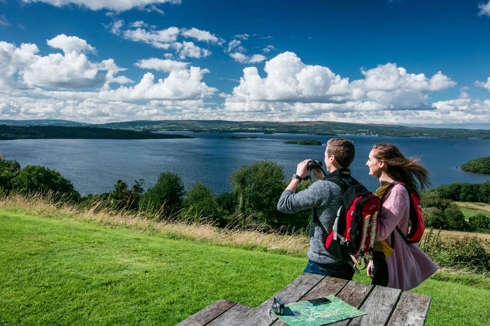 Two people taking photos and admiring the scenery of Lough Derg