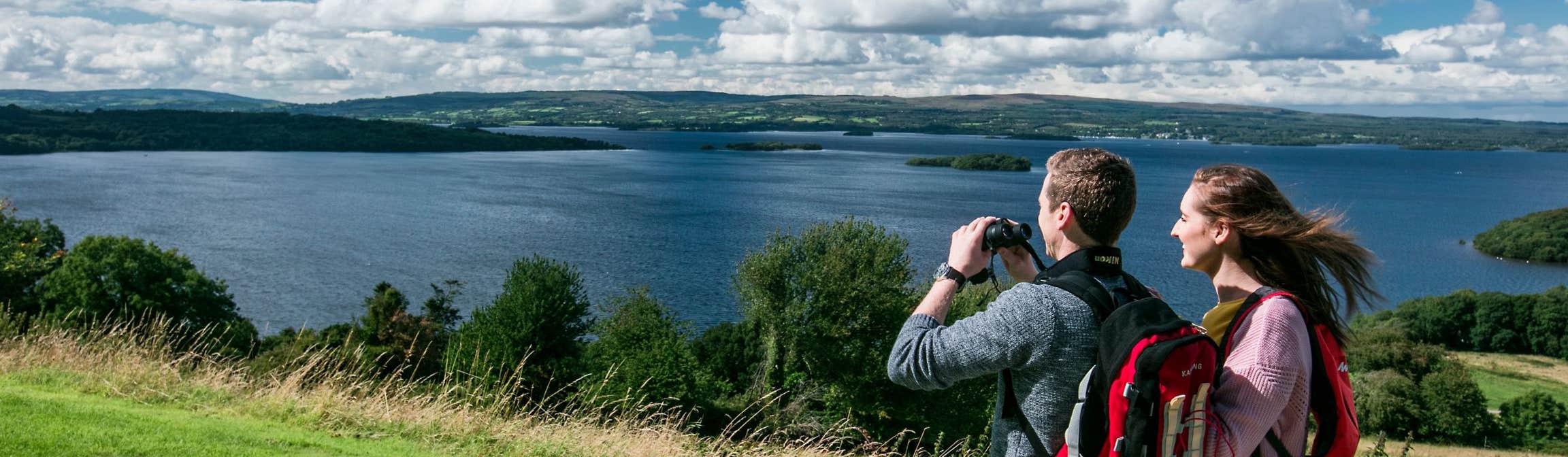 Two people taking photos and admiring the scenery of Lough Derg