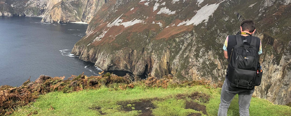 A man looking over at the Slieve League Cliffs