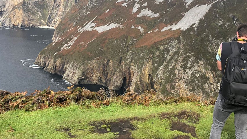 A man looking over at the Slieve League Cliffs