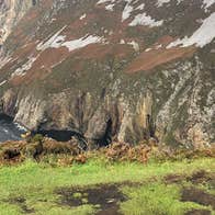 A man looking over at the Slieve League Cliffs