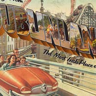 1950s style picture of an orange car on a roller coaster track over a city.