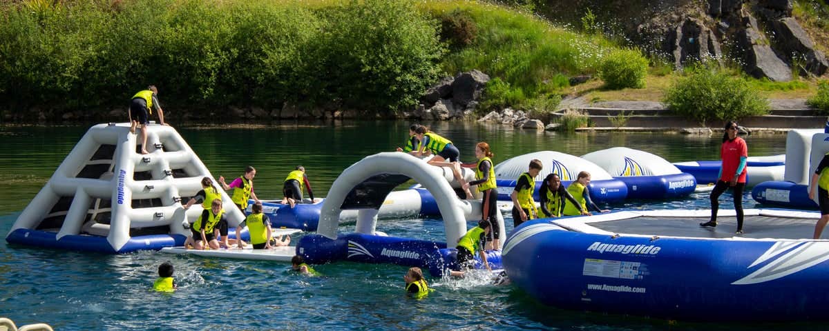 A floating obstacle course on a lake with people on it