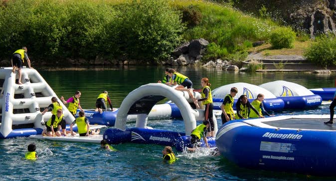 A floating obstacle course on a lake with people on it