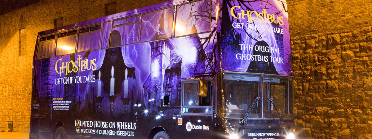 image of the original ghostbus tour bus at night time