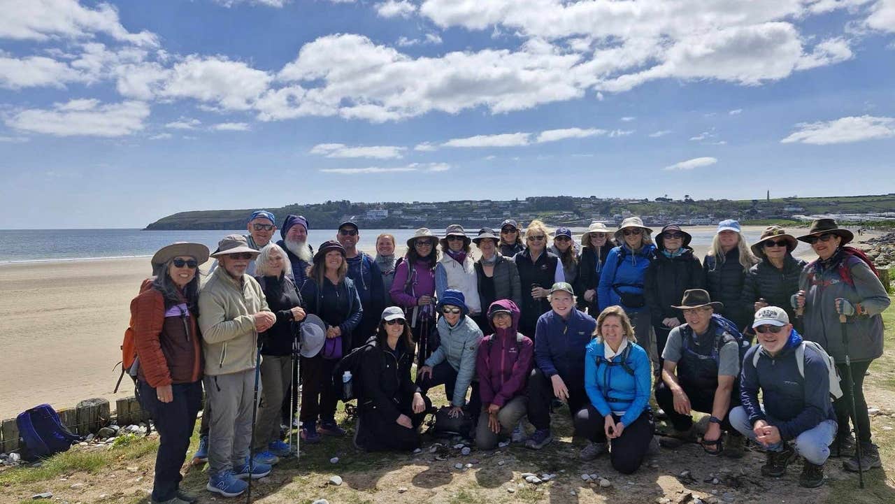 A group of people posing for a photo on a beach