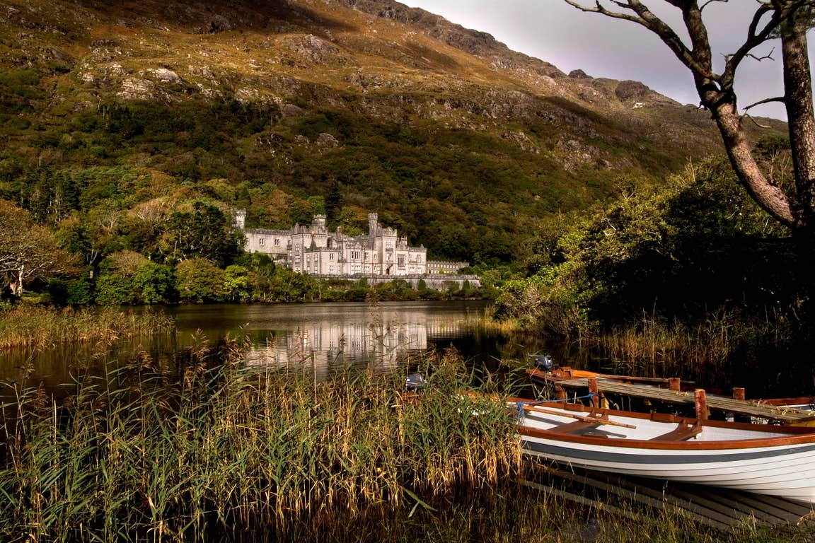 A white wooden boat on the lake near Kylemore Abbey in County Galway