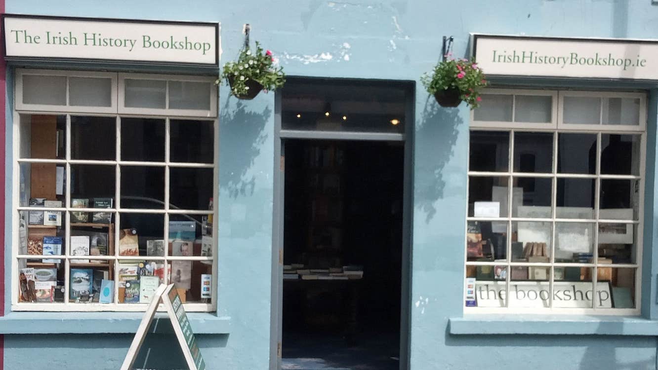 The front facade of an old bookshop painted a light blue colour