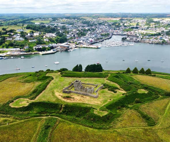 Aerial view of James Fort, Kinsale a historic fortress surrounded by fields and situated next to a river bank.