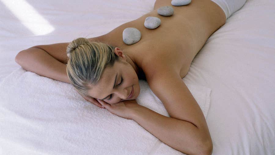 A woman having a hot stone spa treatment