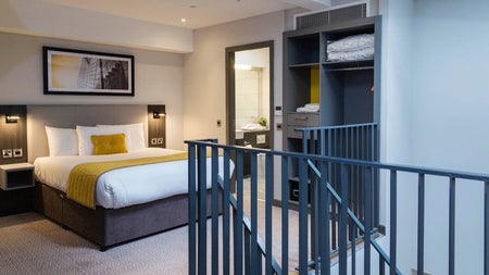 Double bed with white sheets