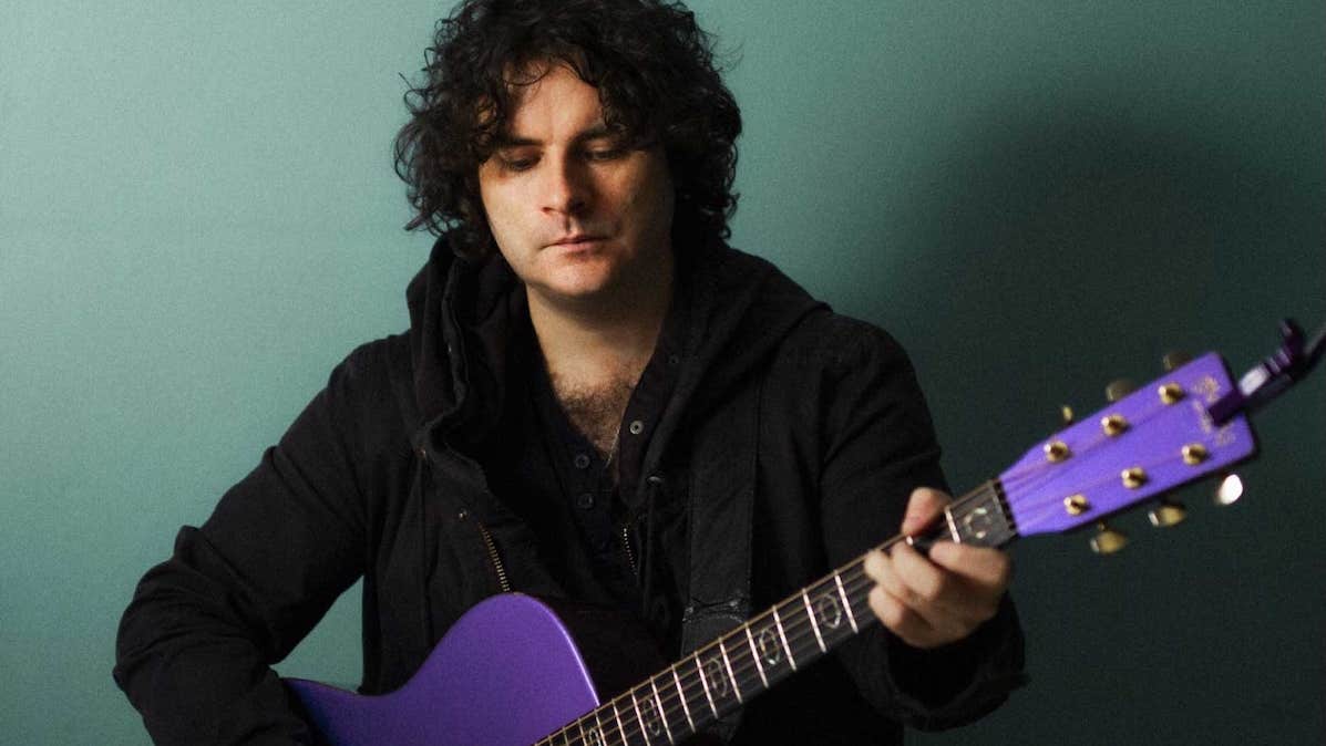 NCH Landmarks: Paddy Casey, a man looking down at purple coloured guitar he is holding