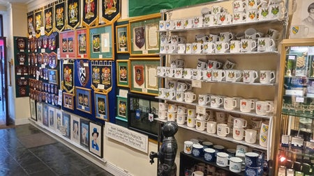 Shop interior with shelves full of heraldic items for sale