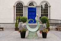 A sculpture outside a bright blue door at King House Georgian Mansion in County Roscommon.