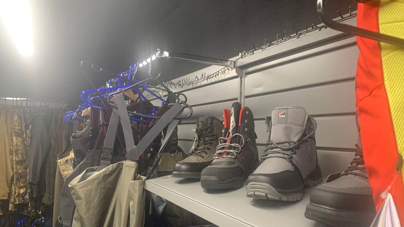 A selection of hiking boots and outdoor clothing for sale