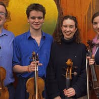 The members of the Meliora Quartet with their instruments.