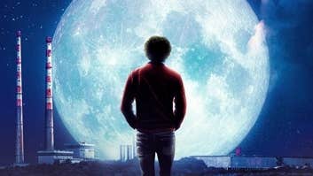 Moonlight - The Philip Lynott Enigma - Rear view of a man walking on cobbled path, silhouetted against a large, bright moon