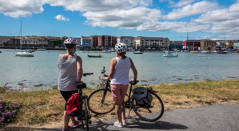 Two people looking at the city on the Waterford Greenway, County Waterford