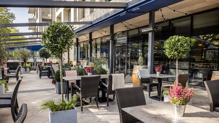 An outdoor terrace with comfortable seating and landscaped surroundings