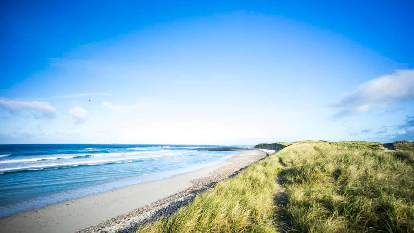 Blue skies meet the Atlantic Ocean at Elly Beach in Belmullet, County Mayo.