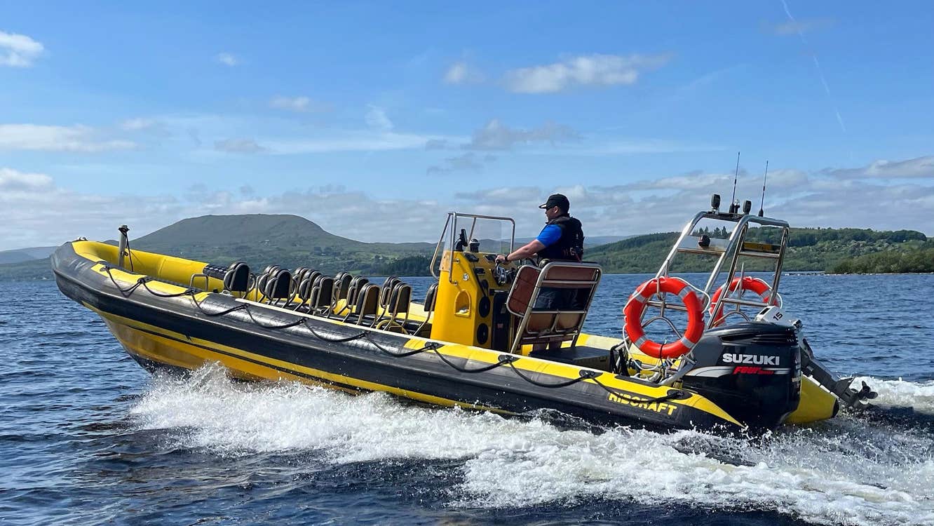 Man on yellow and black RIB at sea with white sea foam around the boat