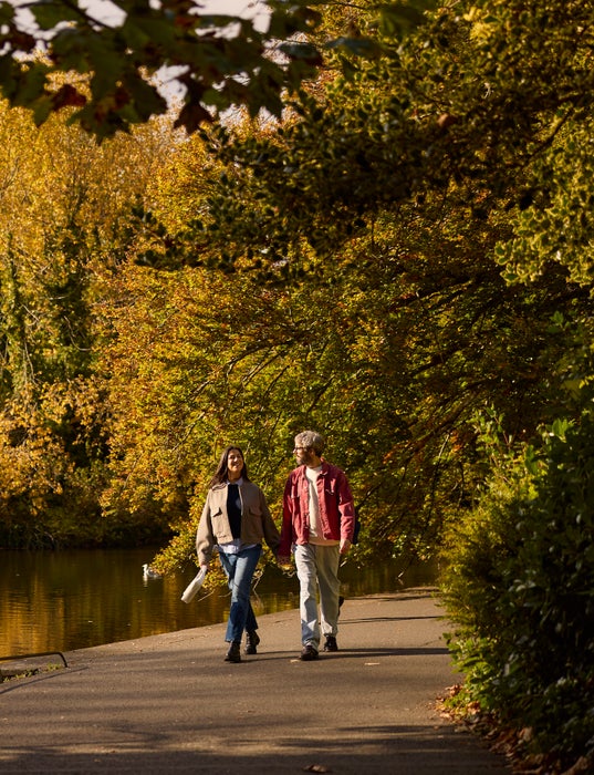 A couple walking in St Stephen's Green in Dublin city