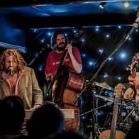 NCH Landmarks: Hothouse Flowers, a group of men playing instruments on a small stage.