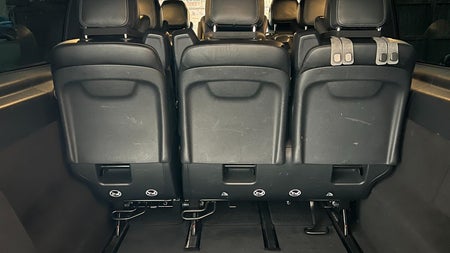 Looking into the back space of a bus with seats