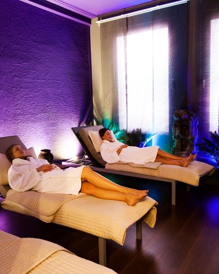 Two robed ladies relax in the Tranquillity Room at Buff Day Spa