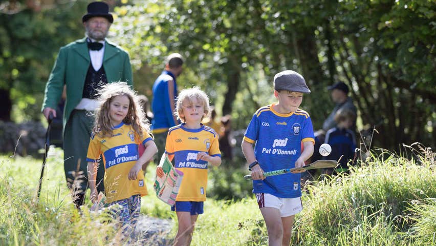 Image of three children and gentleman on a field walking trip on the Cusack Way