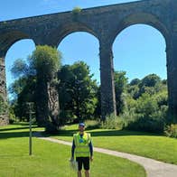 A view of a walking guide standing beside the Kilmacthomas Viaduct