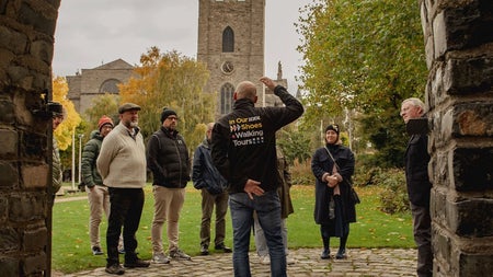 Group on a walking tour stopped listening to the guide of the tour